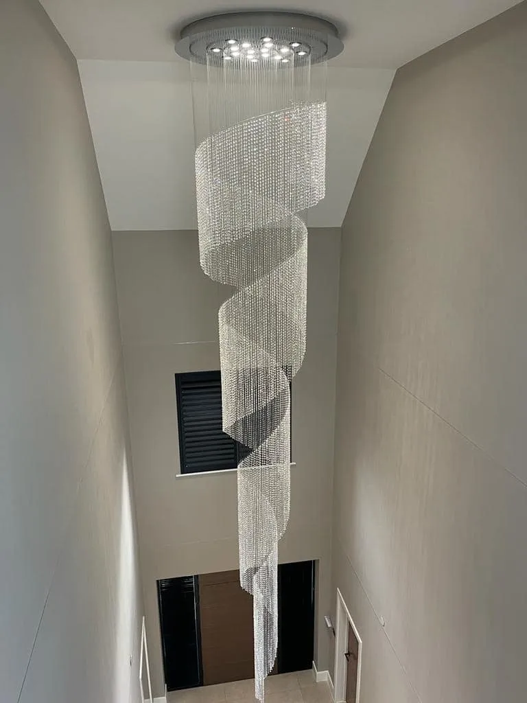 a spiral chandelier hanging from the ceiling in a hallway